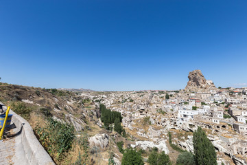 Fototapeta na wymiar View of ancient Nevsehir cave town and a castle of Uchisar dug from a mountains in Cappadocia, Central Anatolia,Turkey. Cappadocia,Kapadokya,Turkish heritage travel. Uchisar pigeon valley.