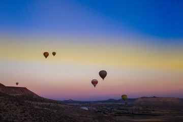 Fototapeta na wymiar Colorful hot air balloons flying over the valley at Cappadocia,Anatolia,Turkey.The great tourist attraction of Cappadocia best places to fly with hot air balloons.NEVSEHIR/TURKEY- JULY 23,2016