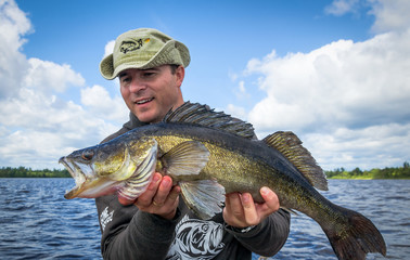 Happy angler with old walleye fish © Piotr Wawrzyniuk