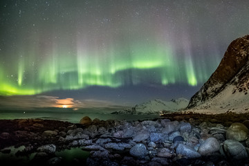 Fototapeta na wymiar Aurora Borealis in Tromso, Norway in front of Norwegian fjord at winter