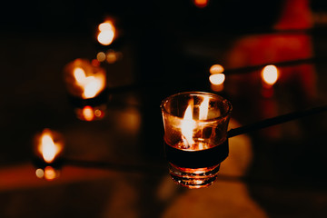 Candles light background and wallpaper. Christmas candles burning at night. candle flames glowing in the dark.