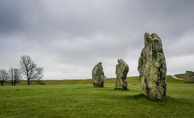 Avebury stone circle under a cloudy sky in winter