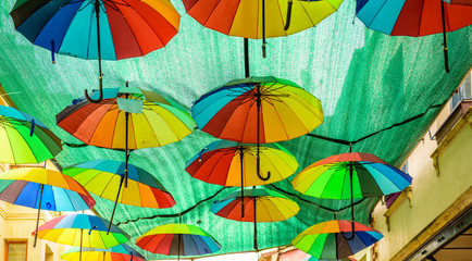 Fototapeta na wymiar Colorful hanging umbrellas above the street.