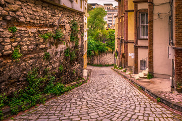 Fototapeta na wymiar ISTANBUL, TURKEY - May 6, 2017: Vintage view of Traditional street and houses at balat area.Street view in historical Balat district. Balat is popular attraction in Istanbul.