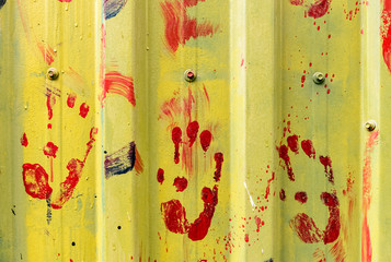 colored hand prints on Metal rustic plate texture surface wall background.