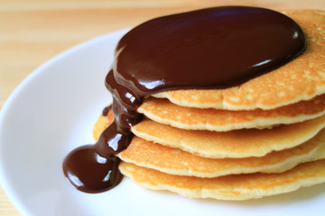 Closed up Stack of Pancakes Served with Hot Belgian Chocolate Sauce  