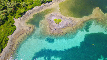 Aerial drone photo of exotic beaches with sapphire and turquoise clear waters, called the "Seychelles" of Greece, Lihadonisia island complex, North Evoia gulf, Greece