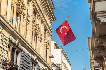 Fototapeta premium ISTANBUL, TURKEY, APRIL 22, 2017: Vintage overview of an old street of Istanbul with a hang Turkish flag on the side.