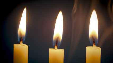 Group of still life  golden candle light with smoke over dark background.  Abstract background for pray or meditation caption and hope concept.