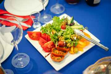 Salad from olives, quail eggs, pepper, cucumber and tomato.