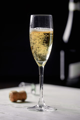 A glass of champagne on a black background