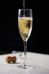 A glass of champagne on a black background