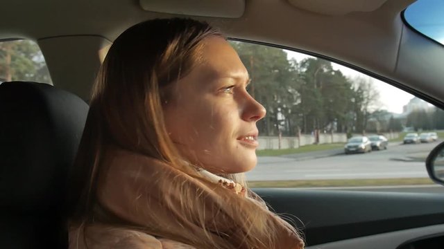 girl driving a car, gorgeous sun flare and grading. Occasional exposure variations are caused by the road signs blinding the sun for a second