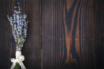 A bunch of lavender on a wooden table.