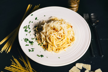 Details of pasta carbonara with bacon, parmesan, yolk and creamy sauce served as main dish in restaurant