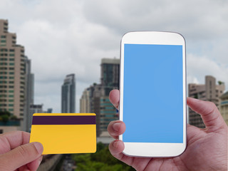 Online Banking on screen with smartphone , Business building background.