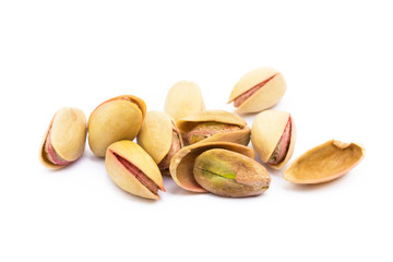 Pile of roasted pistachios isolated on white background