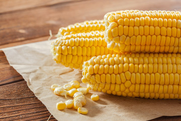 fresh corn on wooden table