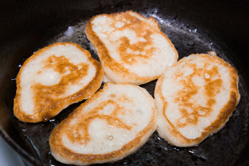 Pancakes fried in a pan in vegetable oil.