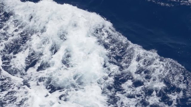 An extreme slow motion close up shot of rippling ocean waves. Shot at 144fps.  	