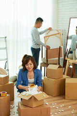 Young Couple Unpacking Moving Boxes