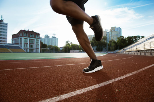 Cropped image of sportsman's legs running