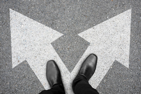 Businessman Making Decision At The Crossroad