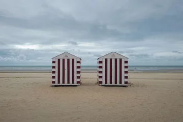 Gordijnen Two colorful beach cabins on a cloudy day © Erik_AJV