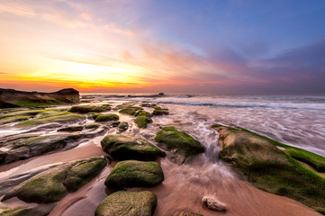 vibrant sunset with green moss at Kudat Sabah Malaysia. Image contain soft focus due to long...
