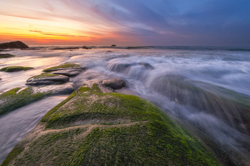 Long expose sunset with waves trails  at Kudat Sabah Malaysia. Image contain soft focus due to long exposure.