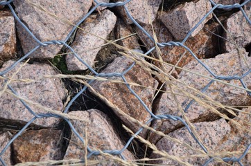 The little stones are under iron wires