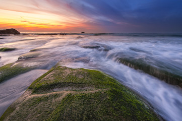 Long expose sunset with waves trails  at Kudat Sabah Malaysia. Image contain soft focus due to long exposure.