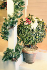 Closeup of Christmas home decoration on terrace with greenery outdoors
