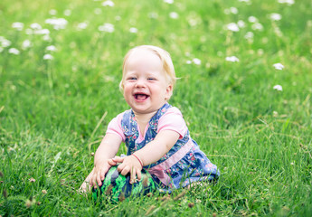 little girl smiling in a park	