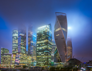 Fototapeta na wymiar Moscow-city at night in the fog and at low clouds