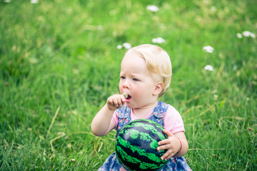 little girl smiling in a park	