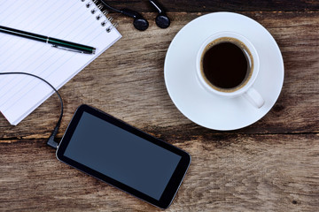 Notepad with phone and coffee cup on desk