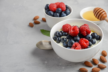 Natural yogurt with fresh berries and honey, healthy breakfast concept, selective focus, copy space
