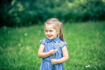 little girl smiling in a park