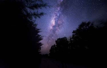 Night sky with Milky Way. Image contain visible noise due to high ISO. Soft focus due to wide aperture and long expose.