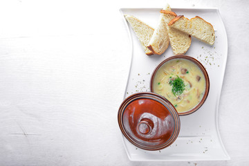 Cream soup of mushrooms. On a wooden background. Top view. Free space for your text.
