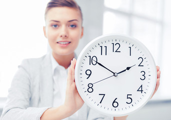 attractive businesswoman with white clock