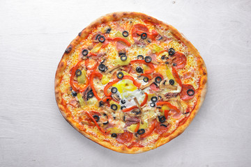 Pizza with vegetables. On a wooden background. Top view. Free space for your text.