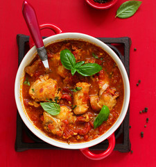 Baked rabbit in tomato sauce with rosemary and basil. Italian Cuisine.