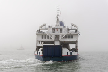 Ferry ship appearing from fog, Portsmouth, UK