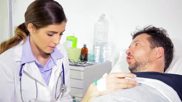 Sick man in hospital bed getting angry with doctor about illness