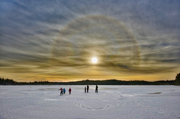 sun halo over frozen lake