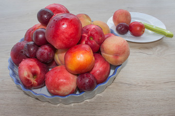 Fruit on the table. Peaches, nectarine, plums. Beautiful sweet peaches, nectarine and plums