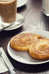 Palmier or Elephant Ears Pastry with a Latte in a European Cafe