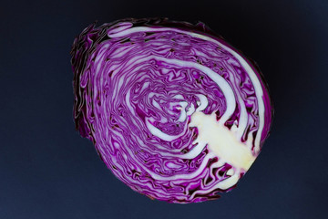 Half purple cabbage on  black background .